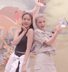 two women standing next to each other with one wearing a black tank top that says " carhartt "
