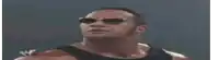 a man wearing sunglasses and a black tank top is looking up at the sky .