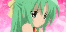 a girl with green hair and big eyes is holding her hand to her mouth .