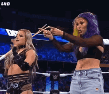 two women wrestling in a ring with chopsticks in their hands