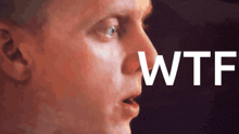 a close up of a man 's face with the word wtf in the corner