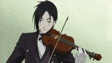 a man in a tuxedo is playing a violin