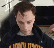 a man wearing a sweatshirt that says ' notre dame ' on the front