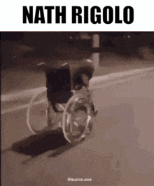 a person in a wheelchair is driving down a street .