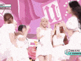 a group of girls are dancing in front of a sign that says ' wicy '
