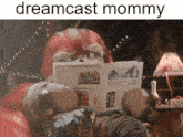 a picture of a stuffed animal reading a newspaper with the words dreamcast mommy above it
