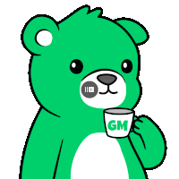 a green teddy bear is holding a cup with the letter gm on it