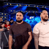 two men are standing next to each other in front of a crowd and the word besto is on the bottom right