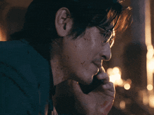 a man with blood on his face is talking on a phone