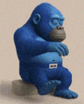 a blue gorilla sitting on a rock with ron on his belt