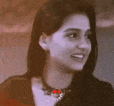 a close up of a woman 's face with a necklace that says love on it