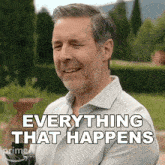 a man with a beard is smiling and says " everything that happens "