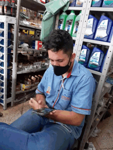 a man wearing a blue shirt that says ' petrol ' on it