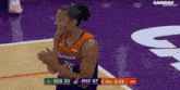 a basketball player with the number 25 on his jersey is clapping his hands