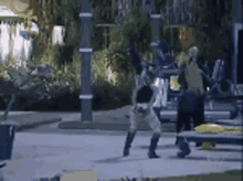 a group of people are standing on a sidewalk in a park at night .