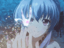 a girl with blue hair is smiling and holding a butterfly in her hand
