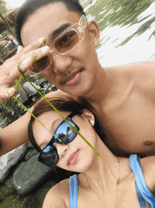 a man and woman wearing sunglasses pose for a photo