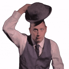 putting on a hat tim robinson i think you should leave with tim robinson wearing a hat having a hat on
