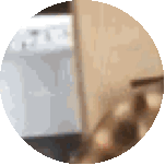 a blurred image of a stove in a circle with a wooden staircase in the background .