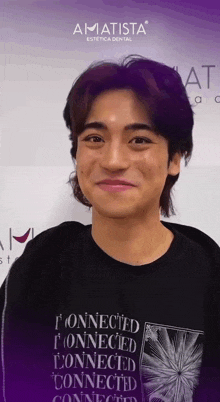 a young man wearing a black shirt that says connected