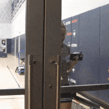 a woman is looking at her phone in front of a wall with uconn written on it