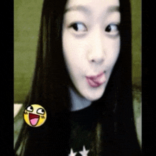 a girl sticking her tongue out with a smiley face on her shoulder
