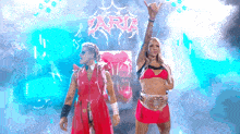 a man and a woman are standing in front of a sign that says aria .