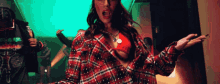 a woman in a plaid shirt is dancing