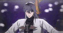 a man with long hair is singing into a microphone with wings on his chest