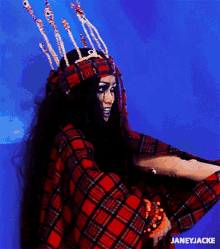a woman wearing a plaid shirt and a crown has the name janeyjacke on the bottom right