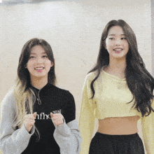two girls are standing next to each other and one has a shirt that says seoul