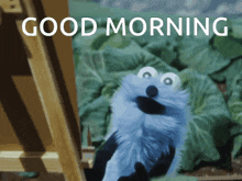 a sesame street character says " good morning " in front of a painting
