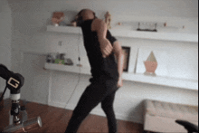 a man in a black shirt is dancing in front of a microphone that has the letter g on it