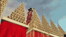a man is pouring a bottle of champagne on top of a red box