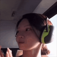 a woman wearing a pair of ear muffs on her head