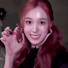 a woman with red hair is holding a pink object