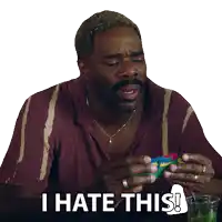 a man sitting at a table with the words i hate this on the bottom