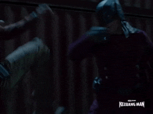 a man is kicking another man with the words keluarga man behind him