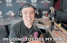 a man wearing headphones says im going to lose my mind in front of a microphone