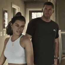 a man in a nike shirt stands next to a woman