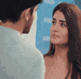 a man and a woman are looking at each other