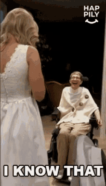 a woman in a wedding dress is standing next to an older woman in a wheelchair who is laughing ..