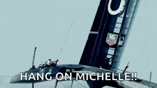 a sailboat is floating on top of a body of water with the words hang on michelle below it .