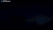 a gif of a sunset with trees in the background