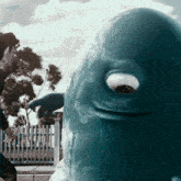 a statue of a blue whale with a large eye