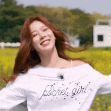 a woman is wearing a white shirt with the word pocket girl on it .
