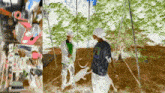 a man wearing a shirt with a picture of a dog on it is standing next to another man on a swing