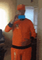 a man in an orange outfit is taking a picture of himself in a mirror