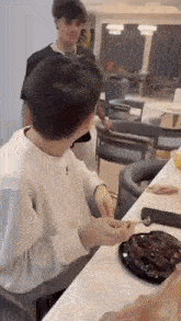 a man is sitting at a table with a plate of food on it