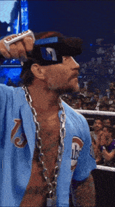 a man with a chain around his neck is wearing a blue shirt with the number 7 on it